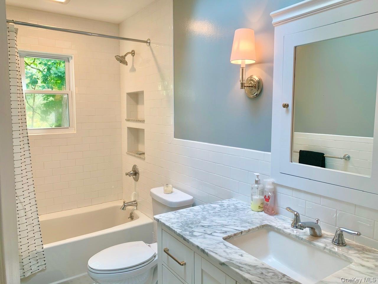 61 Kings Point Road East Hampton, NY 11937 - Photo 9 of 15 Bathroom featuring tasteful backsplash, shower / tub combo, vanity, and tile walls