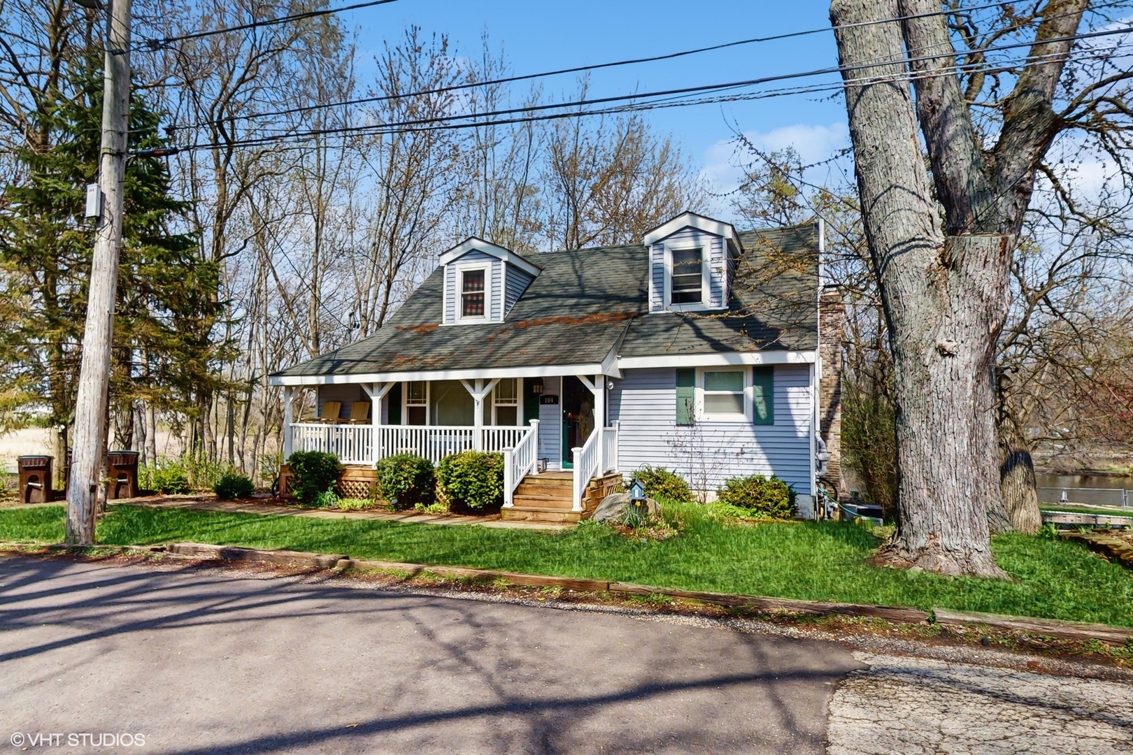 a front view of a house with a garden and plants