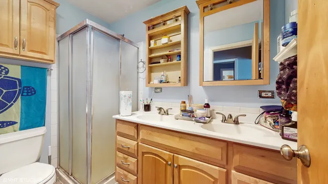 a bathroom with a sink a toilet and shower curtain