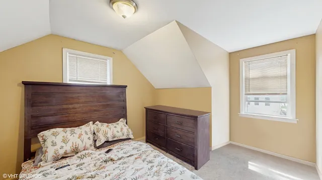 a bedroom with a bed and a fireplace