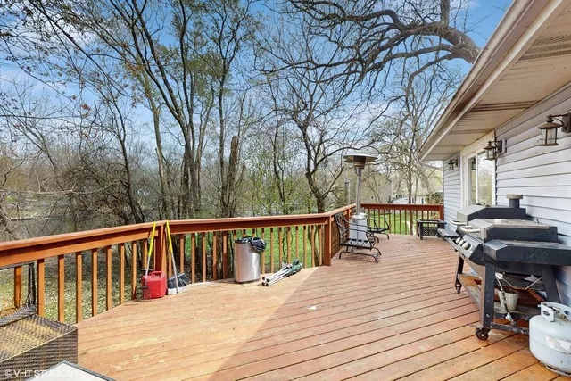 a view of a deck with table and chairs and wooden floor