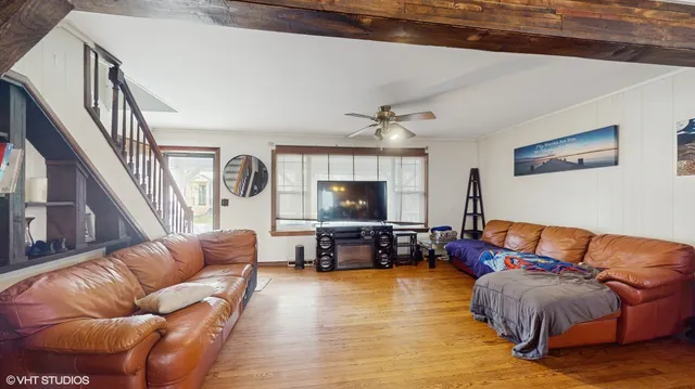 a living room with furniture and a flat screen tv