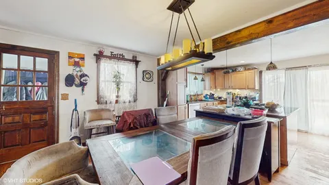 a view of a dining room with furniture and a chandelier