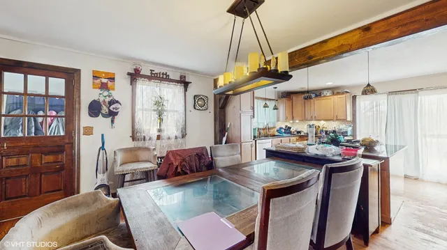 a view of a dining room with furniture and a chandelier