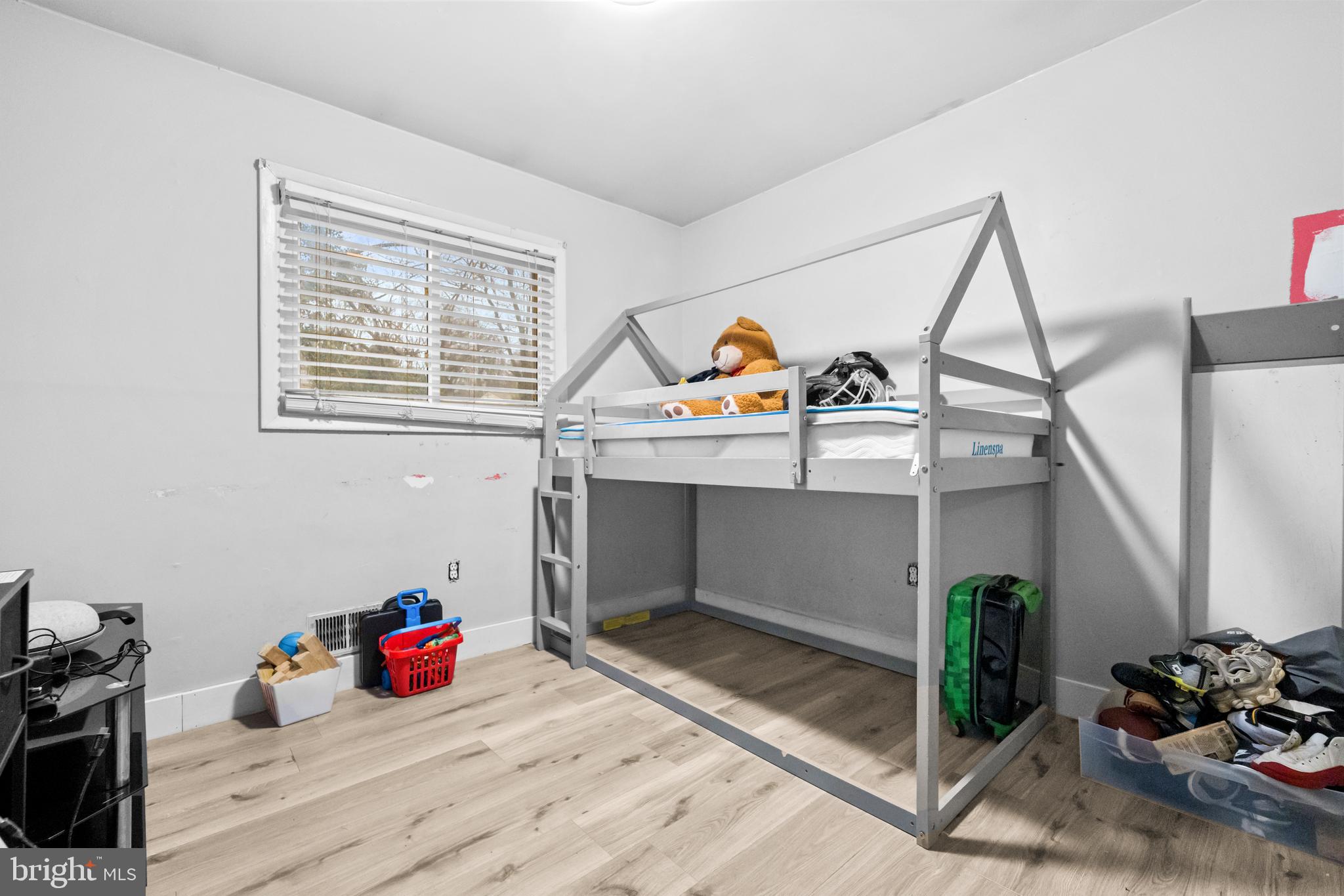 8906 Scheurer Street Lanham, MD 20706 - Photo 11 of 21 a view of a livingroom with wooden floor and white walls