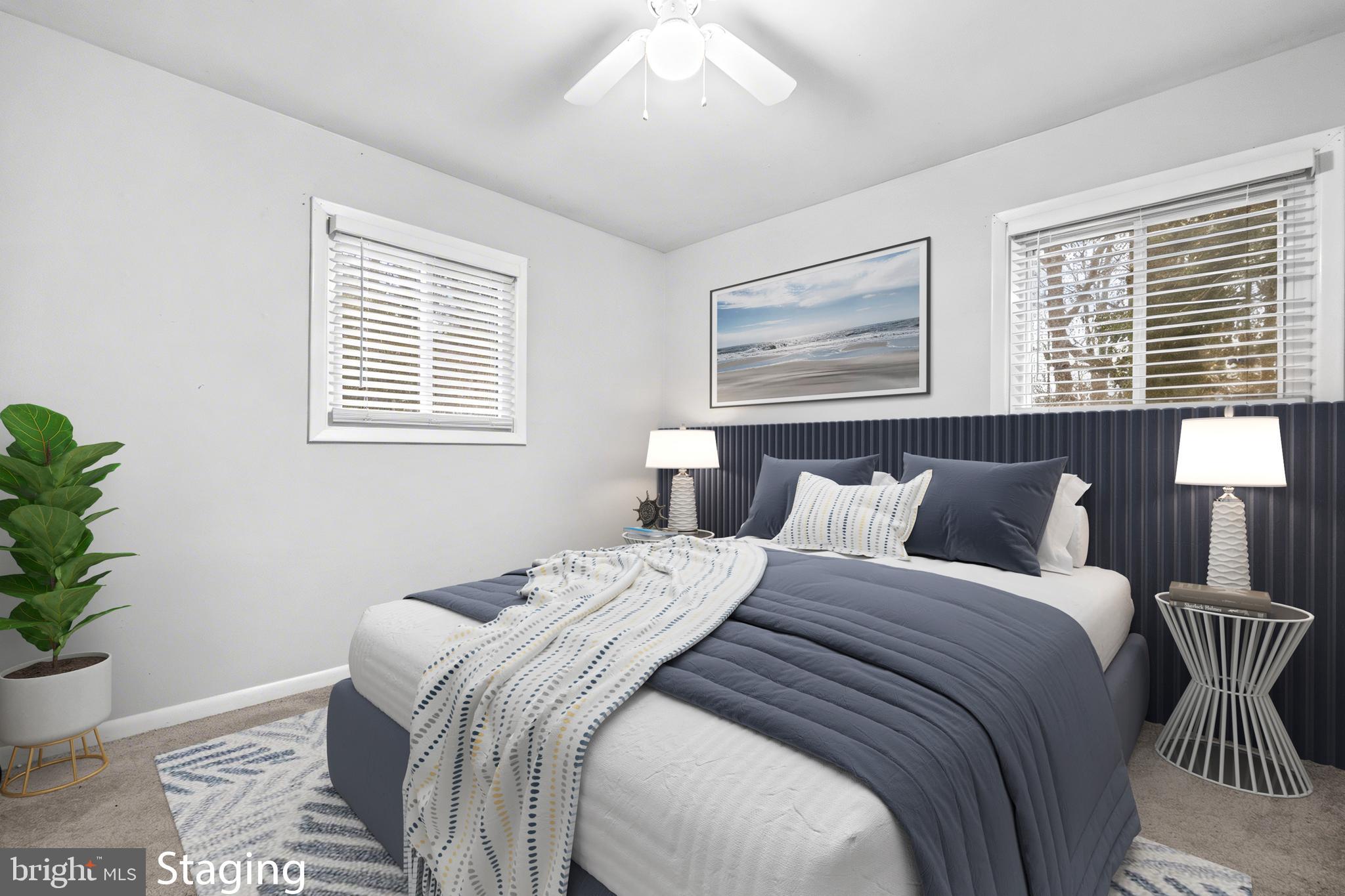 8906 Scheurer Street Lanham, MD 20706 - Photo 14 of 21 a bedroom with a large bed and a potted plant