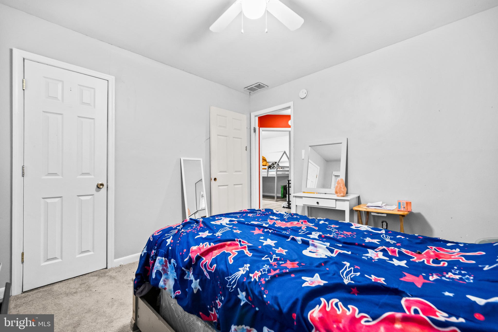 8906 Scheurer Street Lanham, MD 20706 - Photo 15 of 21 a bedroom with a bed and a chandelier