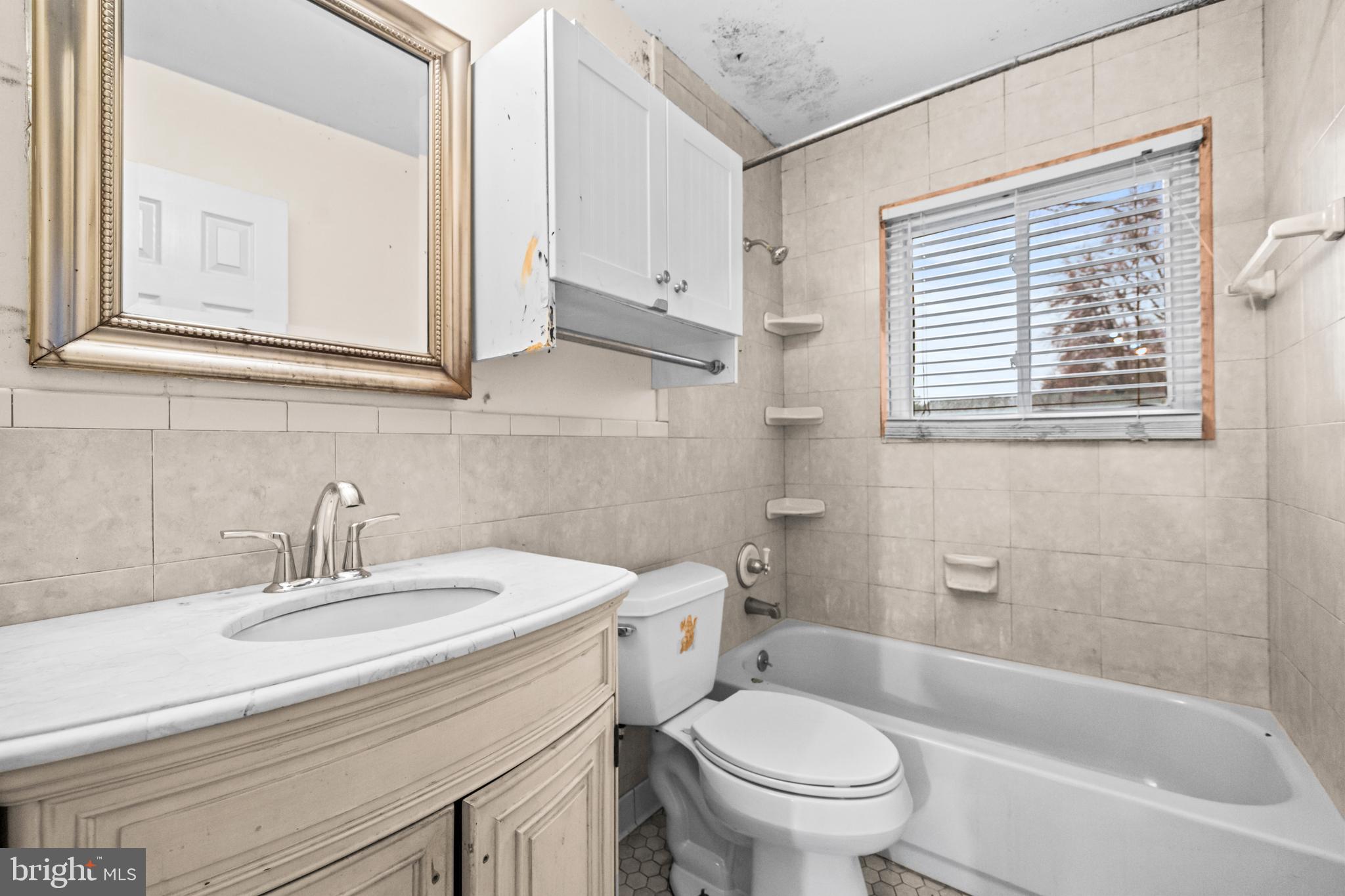 8906 Scheurer Street Lanham, MD 20706 - Photo 16 of 21 a bathroom with a sink a toilet and a bathtub