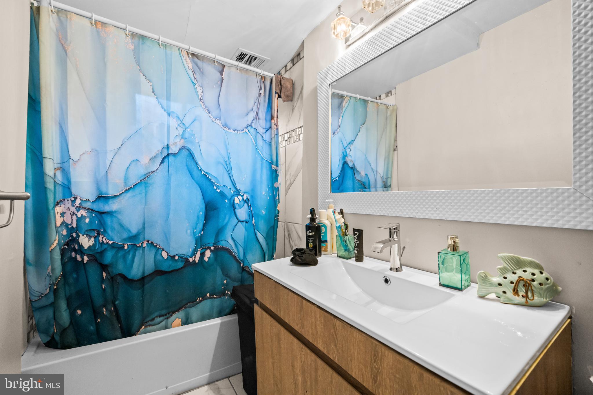 8906 Scheurer Street Lanham, MD 20706 - Photo 19 of 21 a bathroom with a sink and a mirror