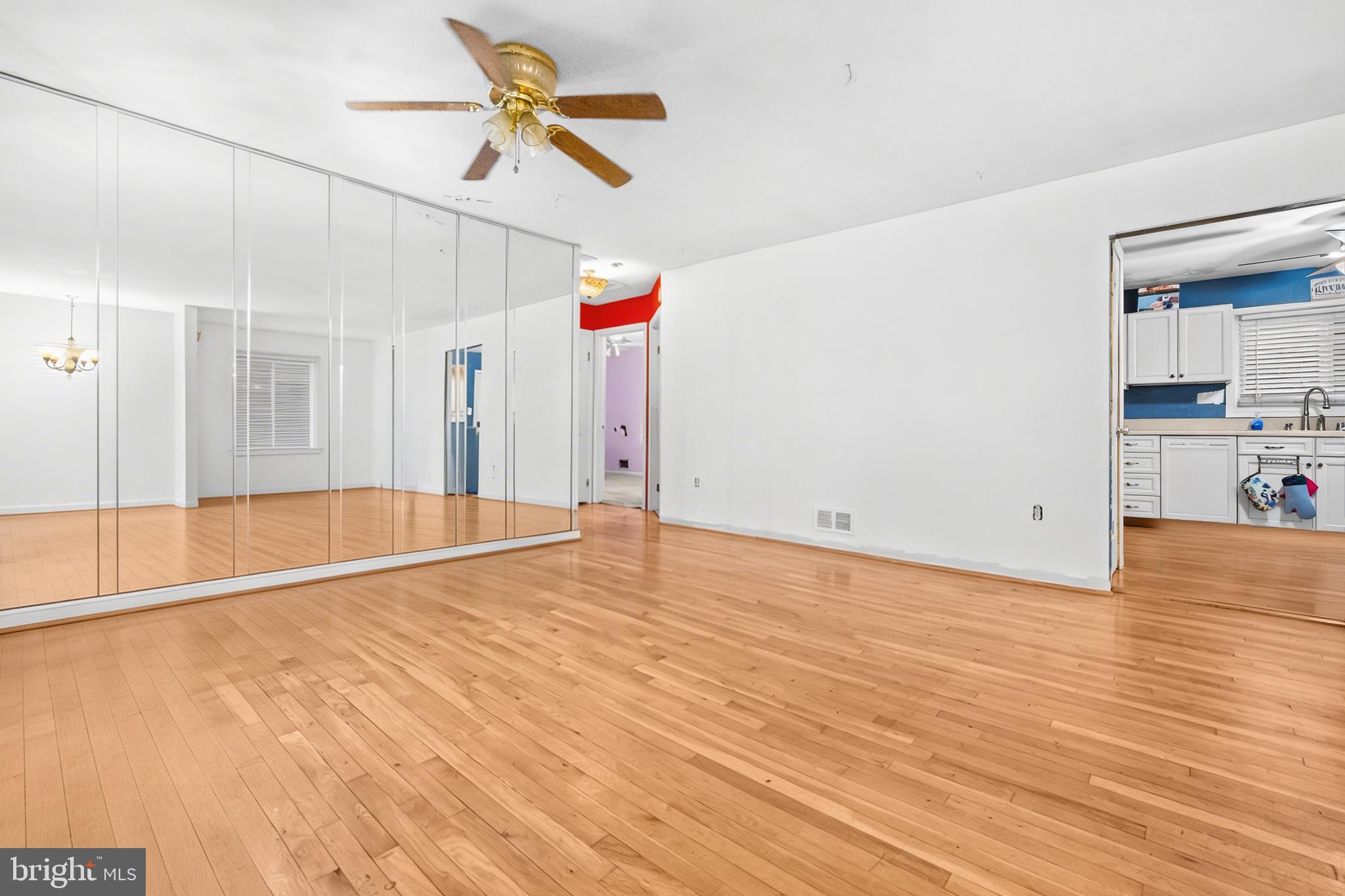 8906 Scheurer Street Lanham, MD 20706 - Photo 4 of 21 a view of empty room with wooden floor and fan