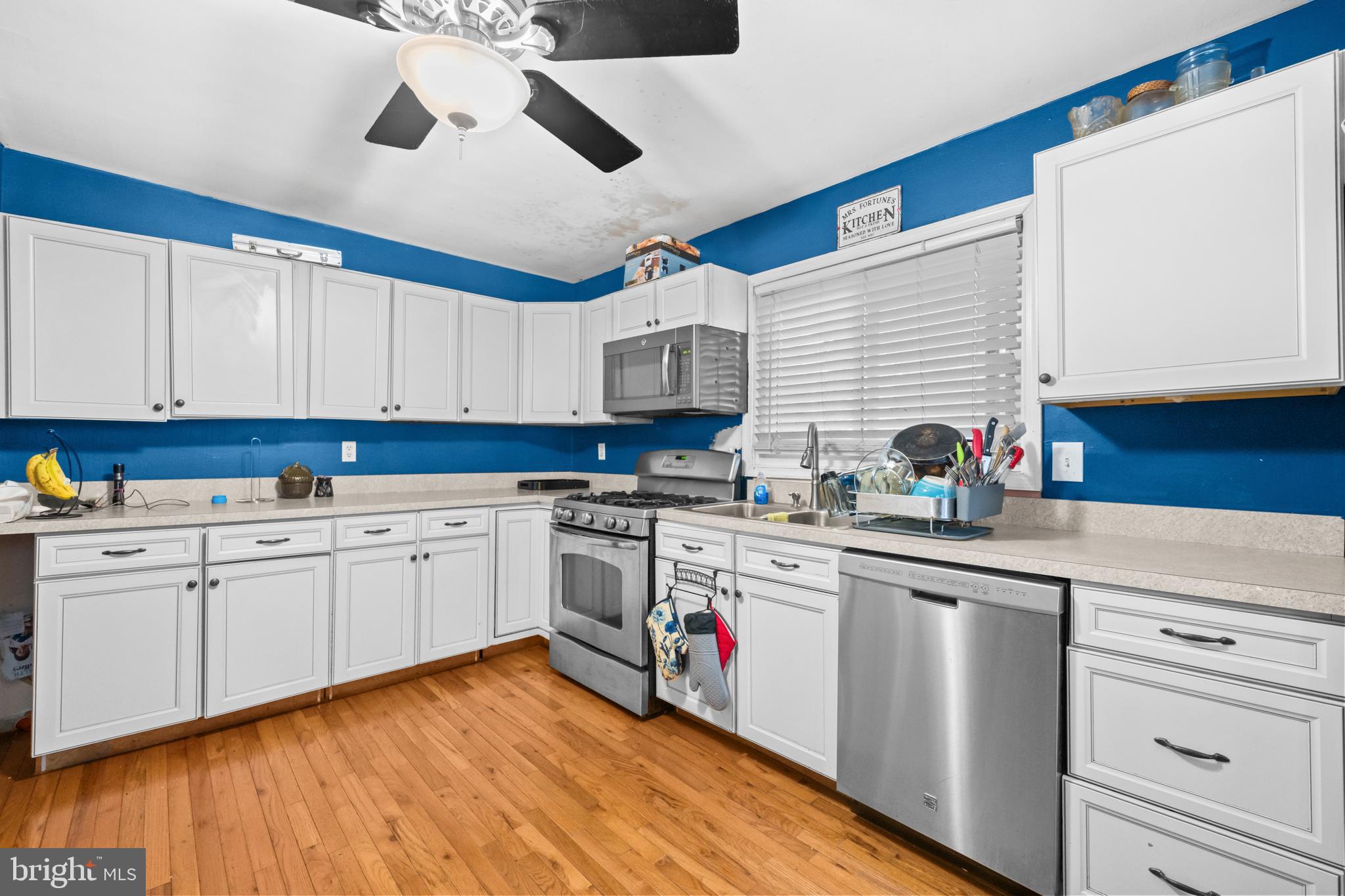 8906 Scheurer Street Lanham, MD 20706 - Photo 9 of 21 a kitchen with granite countertop a sink stainless steel appliances and cabinets