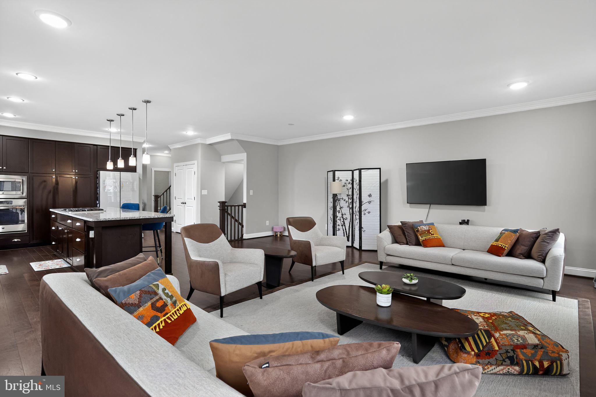 42239 Riggins Ridge Terrace Brambleton, VA 20148 - Photo 11 of 30 a living room with furniture and a flat screen tv