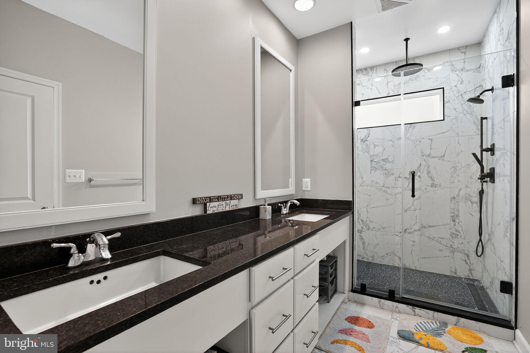 42239 Riggins Ridge Terrace Brambleton, VA 20148 - Photo 18 of 30 a bathroom with a sink and a mirror