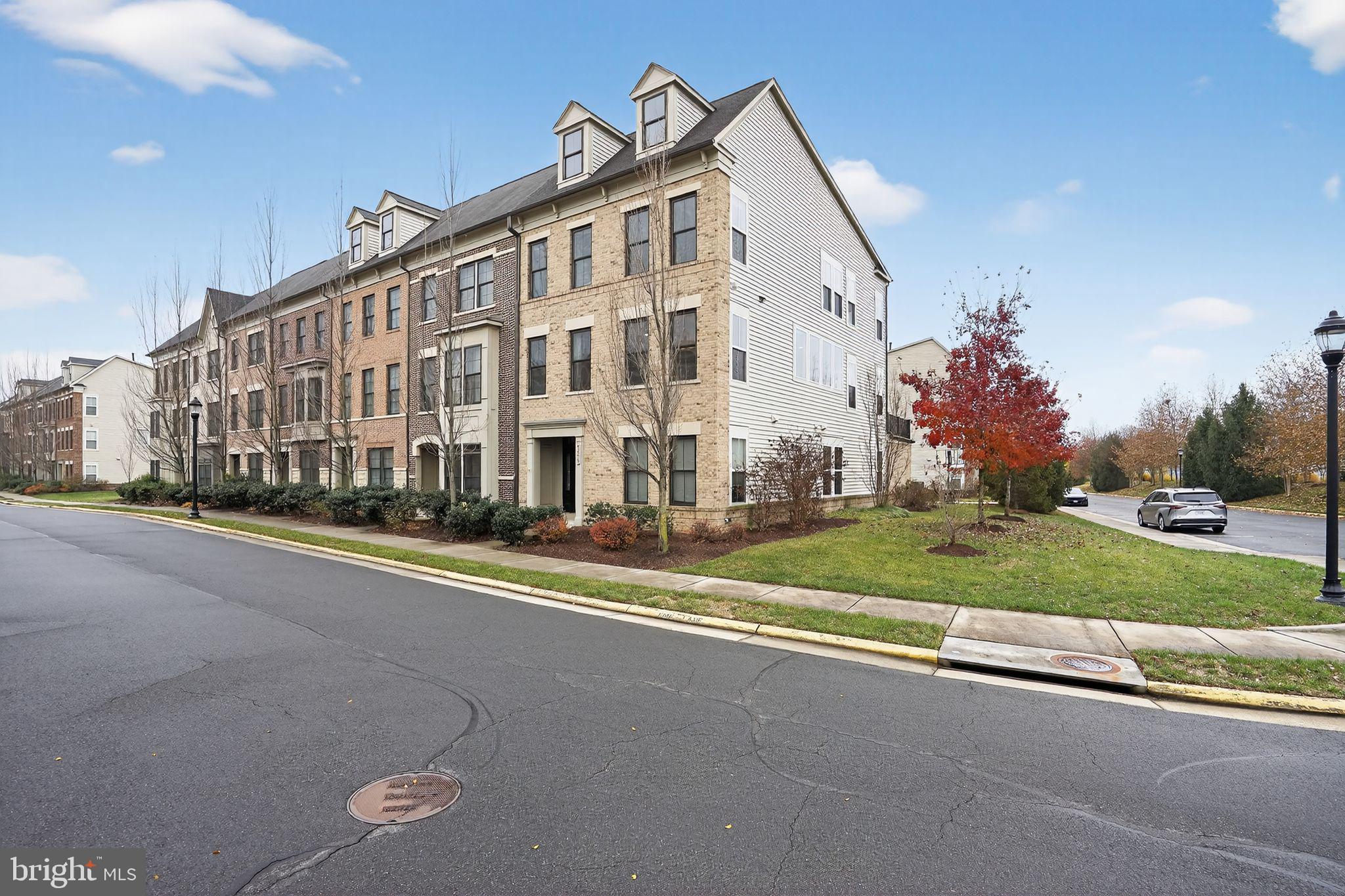 42239 Riggins Ridge Terrace Brambleton, VA 20148 - Photo 2 of 30 a view of a big building next to a road