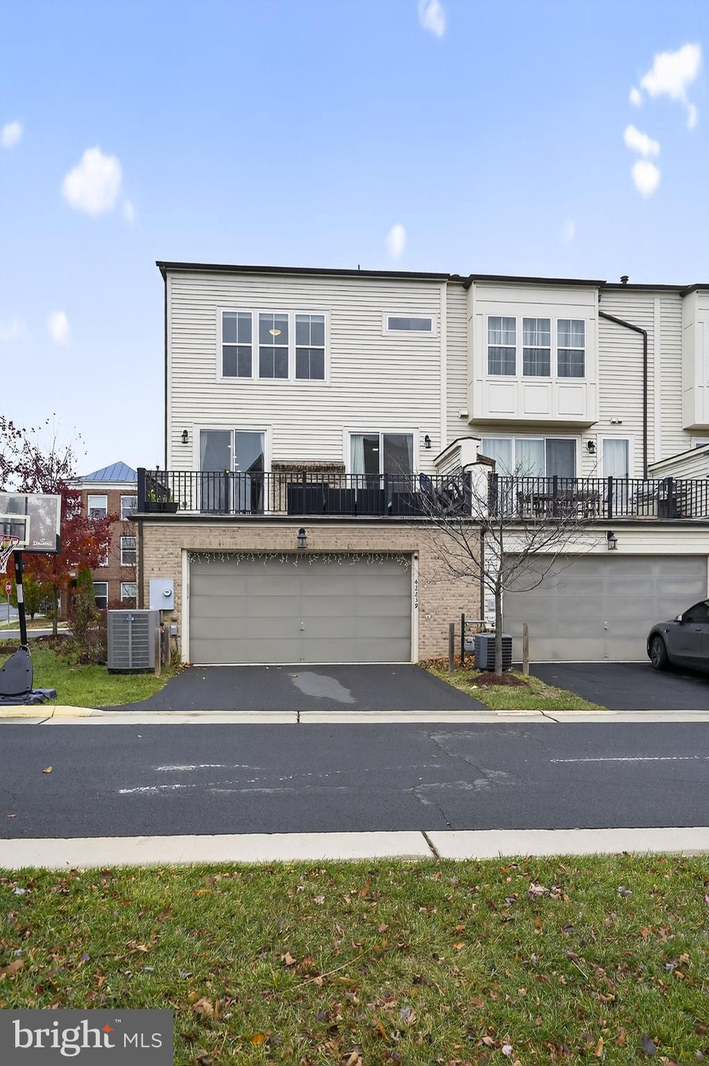 42239 Riggins Ridge Terrace Brambleton, VA 20148 - Photo 29 of 30 a front view of a house with a garden and lake view
