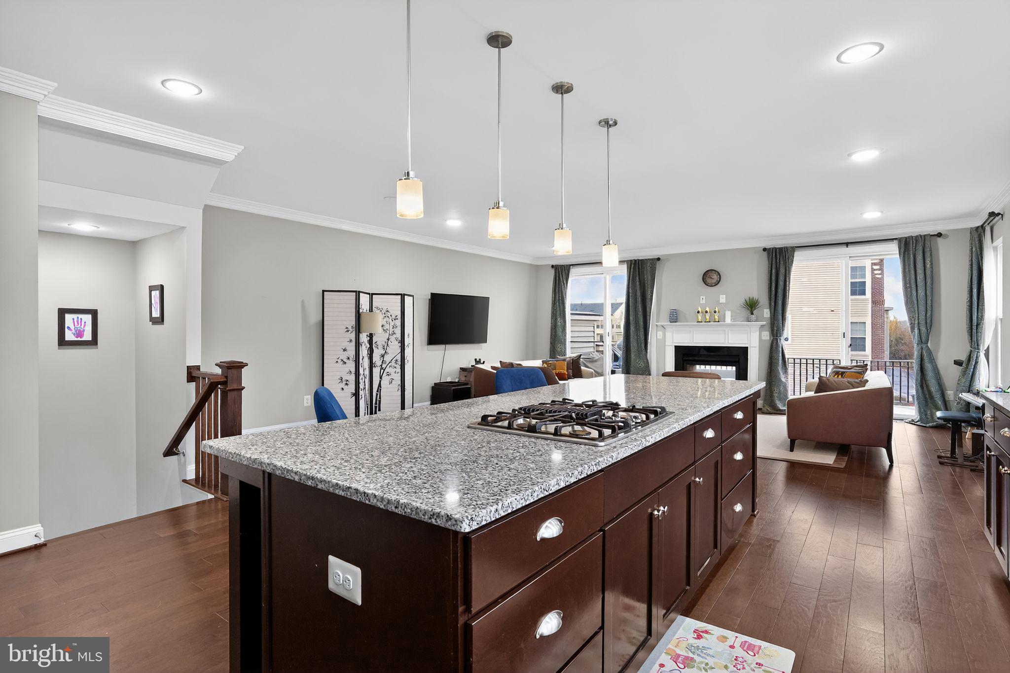 42239 Riggins Ridge Terrace Brambleton, VA 20148 - Photo 7 of 30 a open kitchen with stainless steel appliances granite countertop a stove and a refrigerator