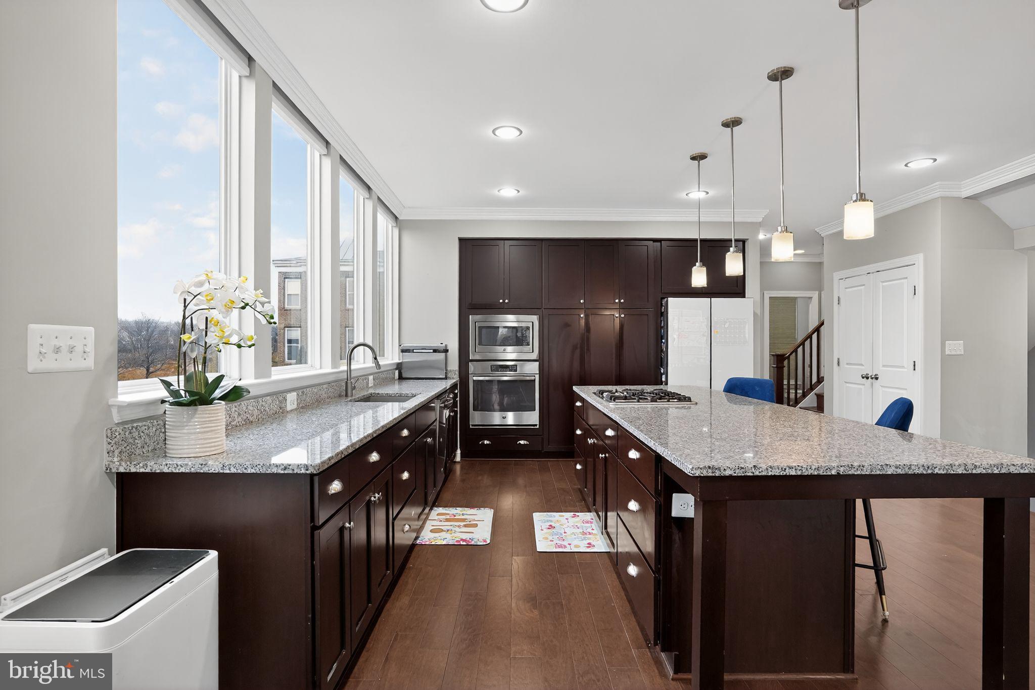 42239 Riggins Ridge Terrace Brambleton, VA 20148 - Photo 8 of 30 a kitchen with lots of counter space and stainless steel appliances