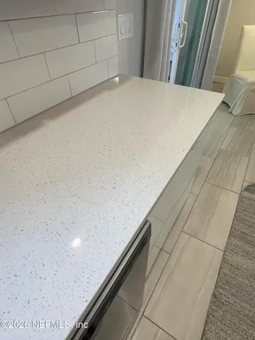 a stove top oven sitting inside of a kitchen