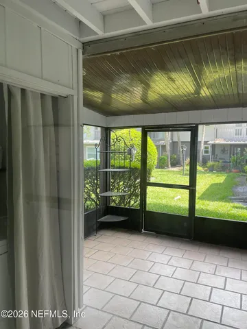 a picture of a glass door with table and chairs