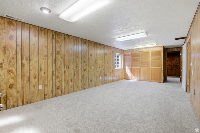 2348 North 770 West Clinton, UT 84015 - Photo 14 of 25 Spacious room featuring light wood paneling, light-colored carpeting, a window with horizontal blinds, and a built-in folding wood screen