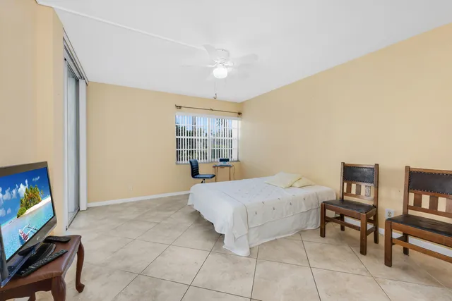 a living room with a bed furniture and a flat screen tv