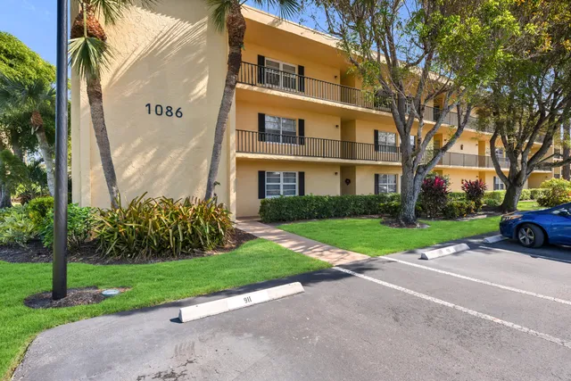a front view of a residential apartment building with a yard