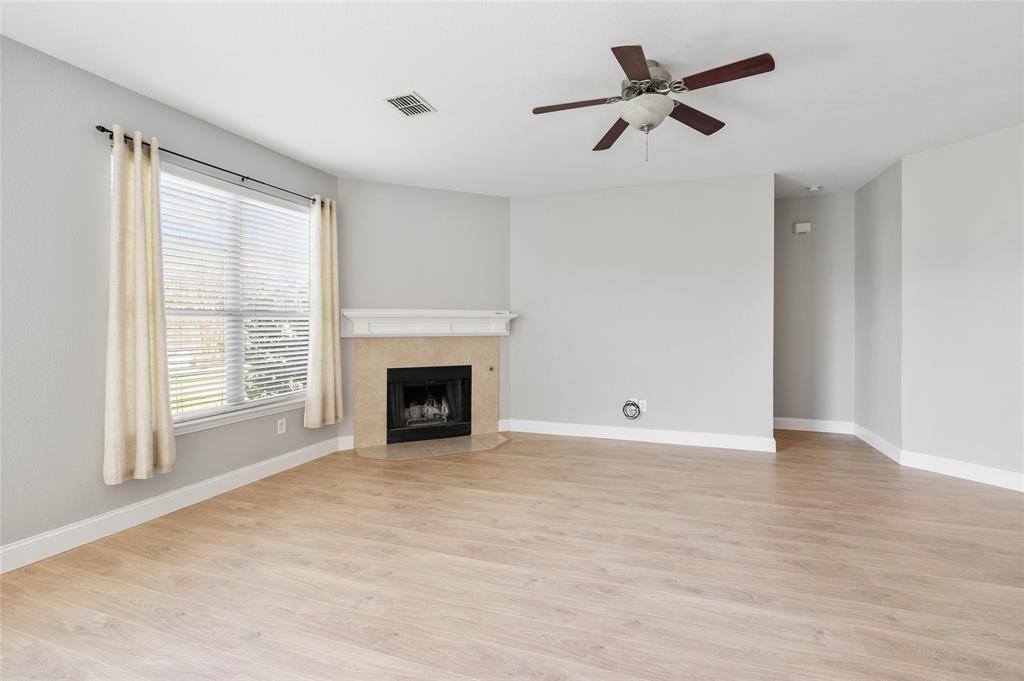 1514 Hanover Lane Van Alstyne, TX 75495 - Photo 15 of 39 a view of an empty room with a fireplace and a window