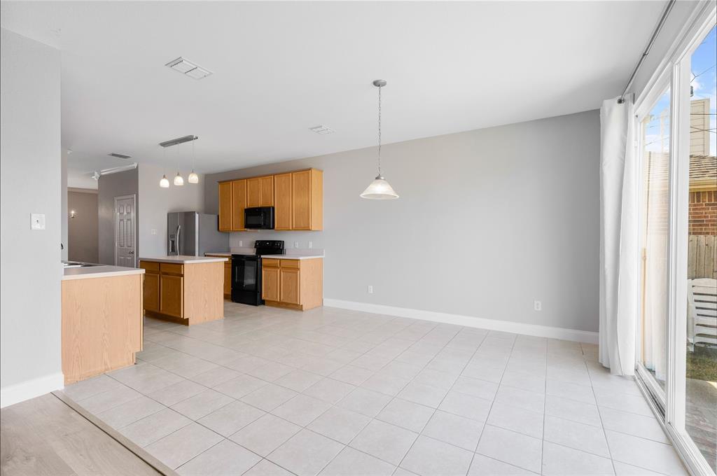 1514 Hanover Lane Van Alstyne, TX 75495 - Photo 17 of 39 a view of a kitchen with a sink and a microwave