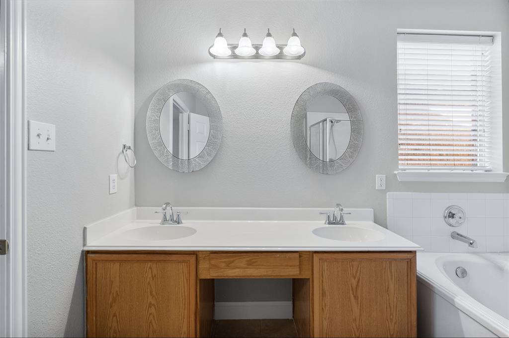 1514 Hanover Lane Van Alstyne, TX 75495 - Photo 27 of 39 a bathroom with a sink and a mirror