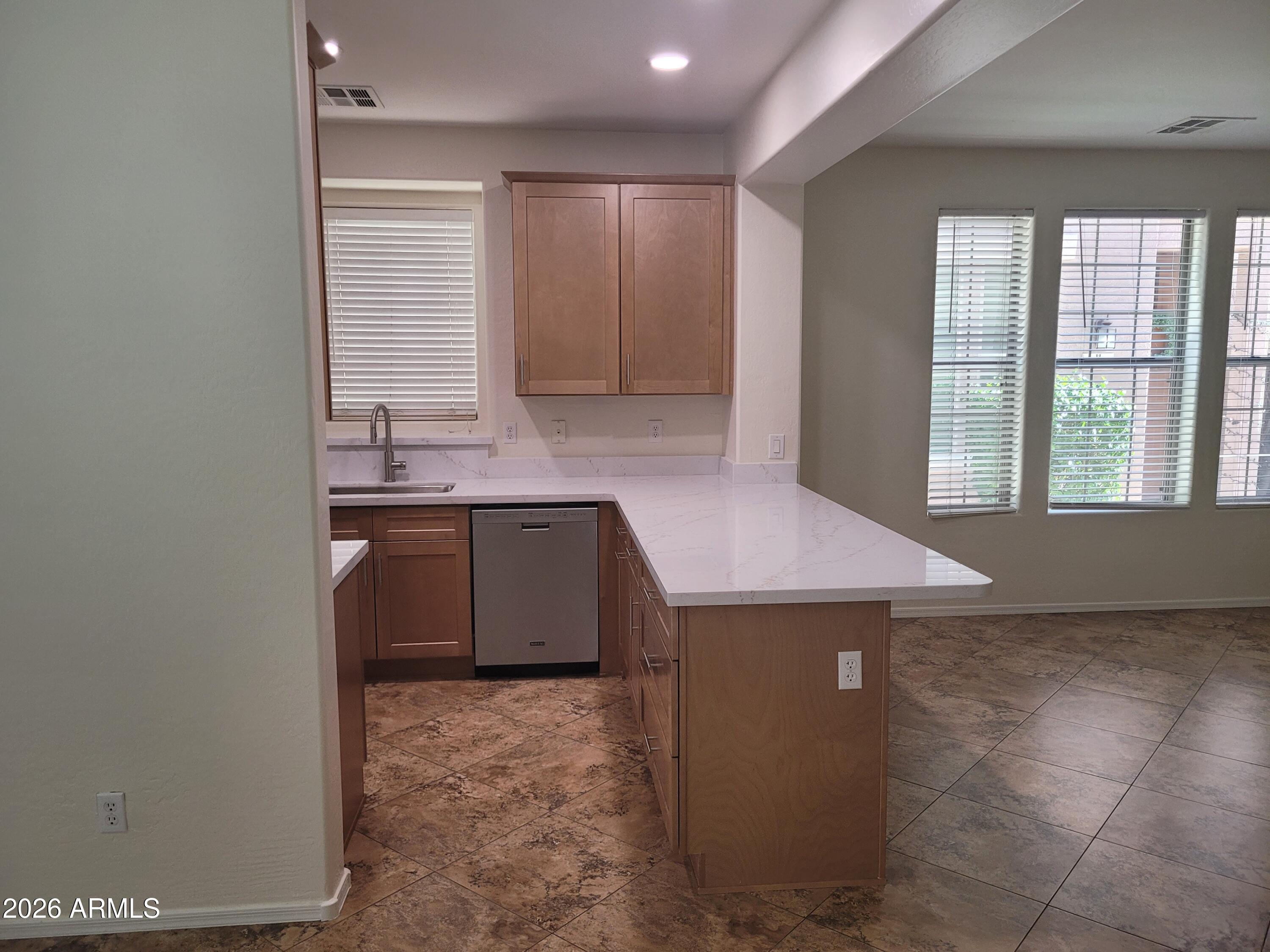 1453 South Sinova Avenue Gilbert, AZ 85296 - Photo 6 of 46 a view of a kitchen with a sink and dishwasher