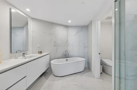 a bathroom with a shower a toilet and sink