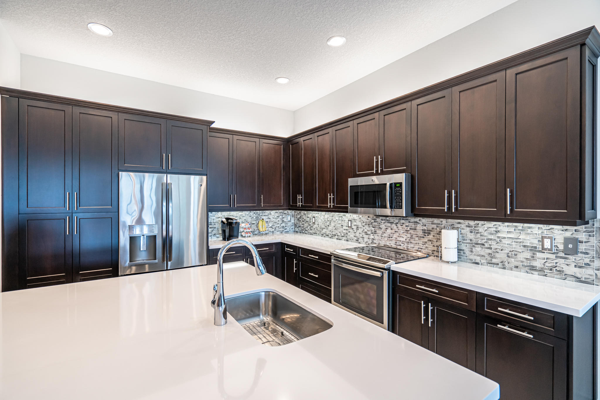 12591 Bonnington Range Drive Boynton Beach, FL 33473 - Photo 11 of 62 a kitchen with kitchen island a sink appliances and cabinets