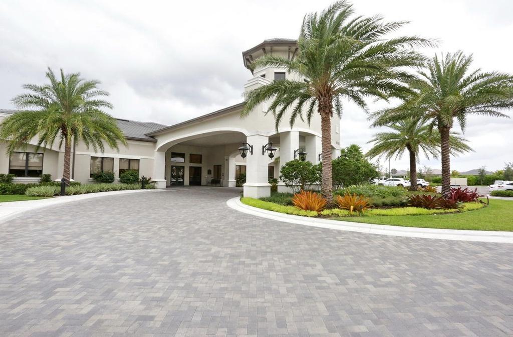 12591 Bonnington Range Drive Boynton Beach, FL 33473 - Photo 41 of 62 a view of a house with a yard and potted plants