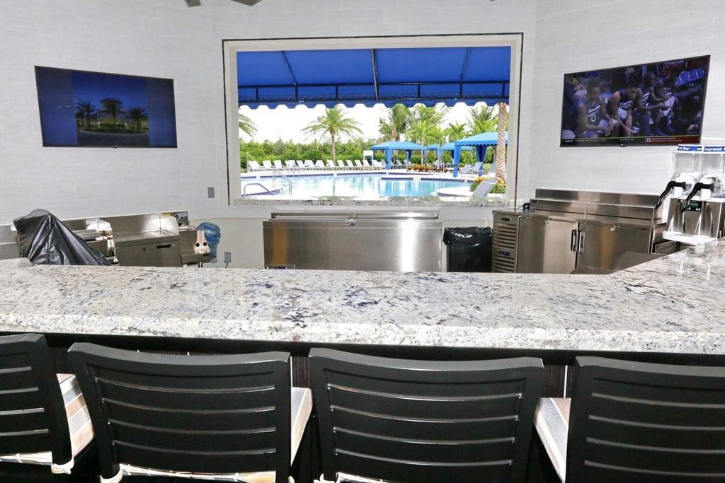 12591 Bonnington Range Drive Boynton Beach, FL 33473 - Photo 47 of 62 a kitchen with stainless steel appliances kitchen island a stove and a sink
