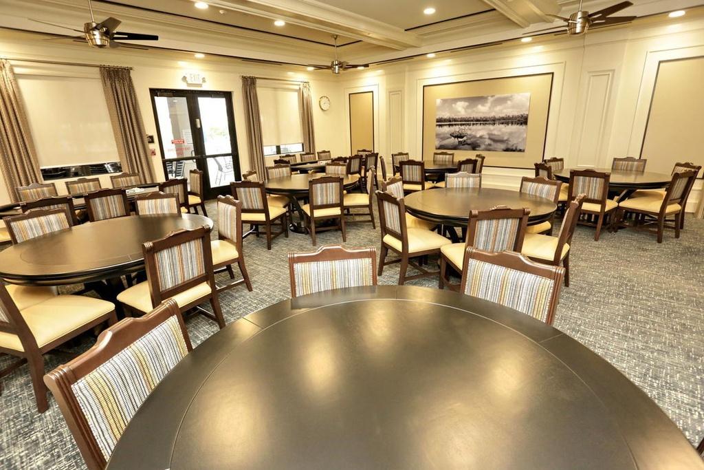 12591 Bonnington Range Drive Boynton Beach, FL 33473 - Photo 48 of 62 a room with lots of table and chairs