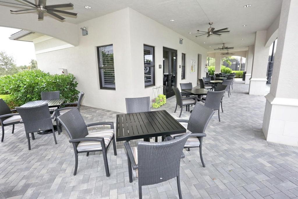 12591 Bonnington Range Drive Boynton Beach, FL 33473 - Photo 61 of 62 a view of a dining room with furniture window and wooden floor