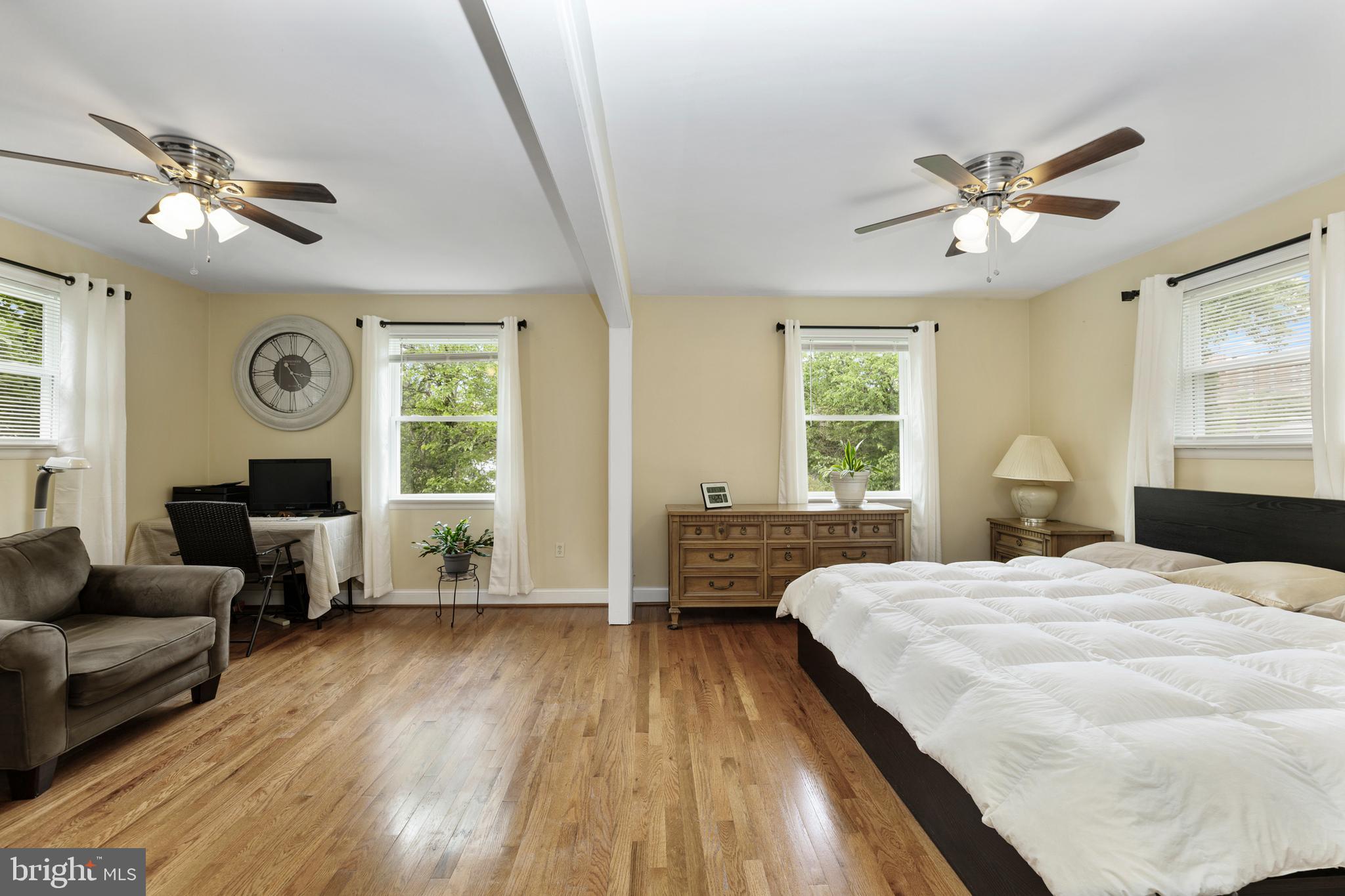 123 Walnut Street Northwest Washington, DC 20012 - Photo 11 of 38 a spacious bedroom with a large bed and a couch