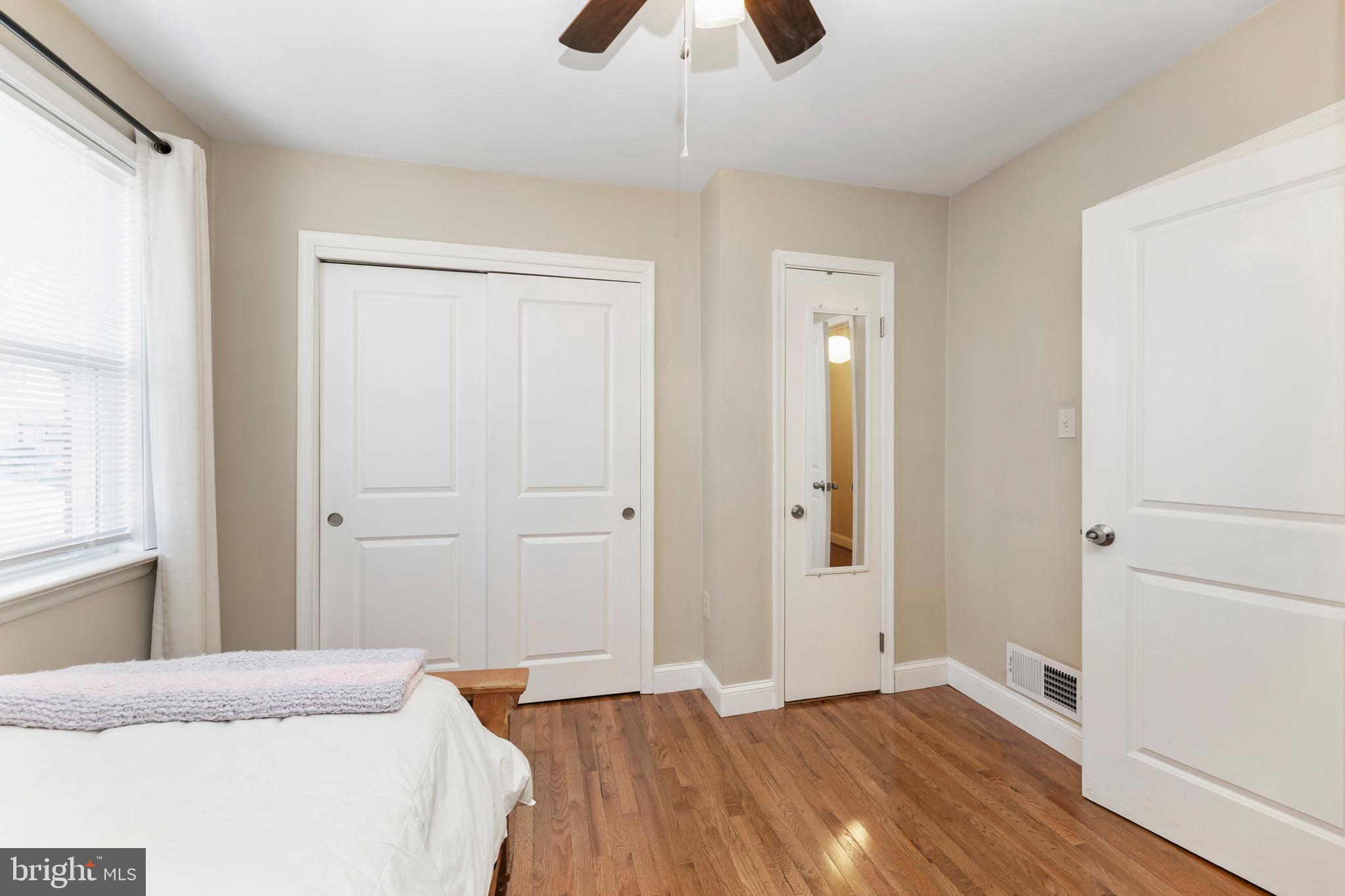123 Walnut Street Northwest Washington, DC 20012 - Photo 17 of 38 a bedroom with a bed and a chandelier