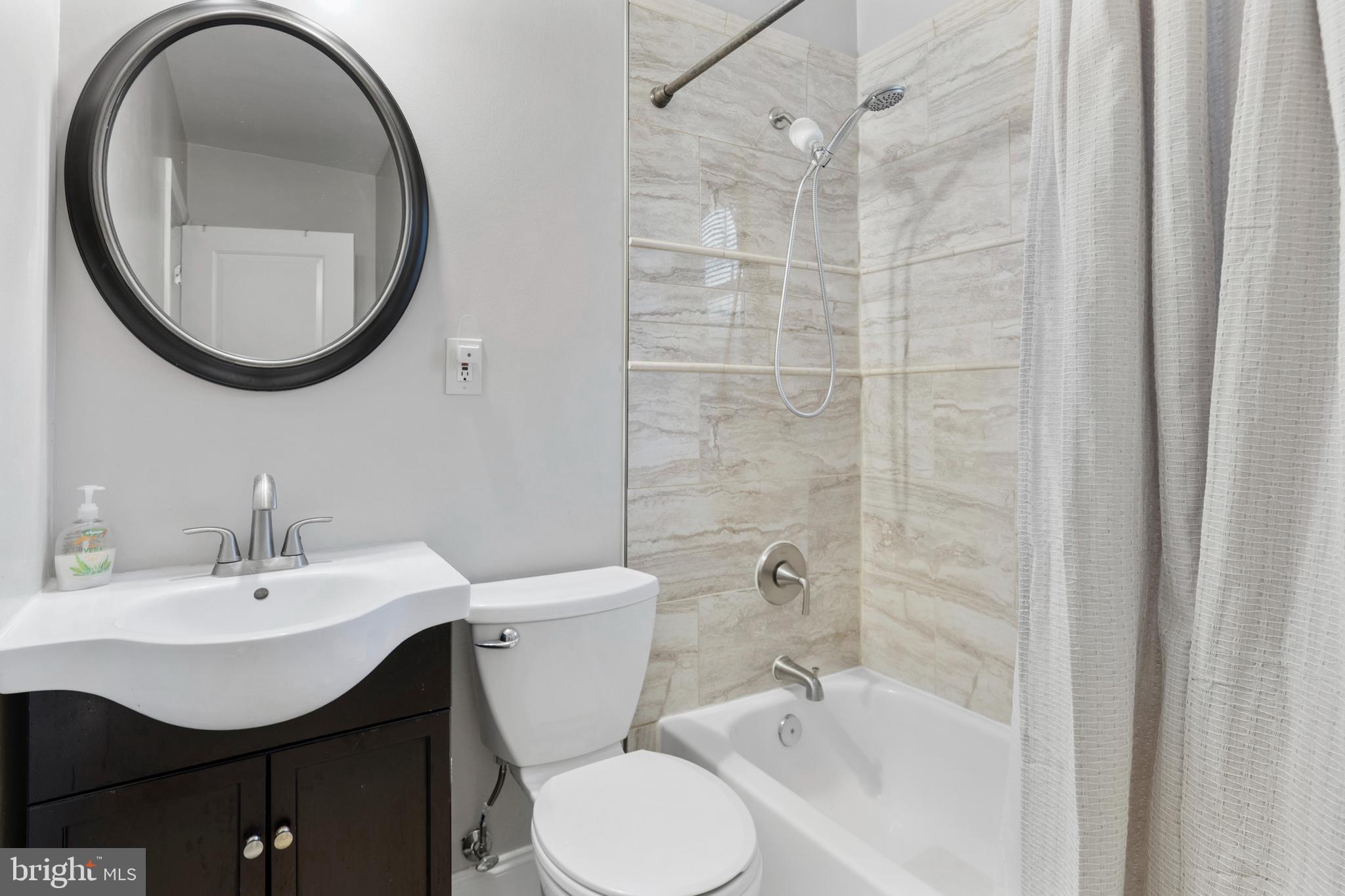 123 Walnut Street Northwest Washington, DC 20012 - Photo 19 of 38 a bathroom with a sink a toilet and a mirror