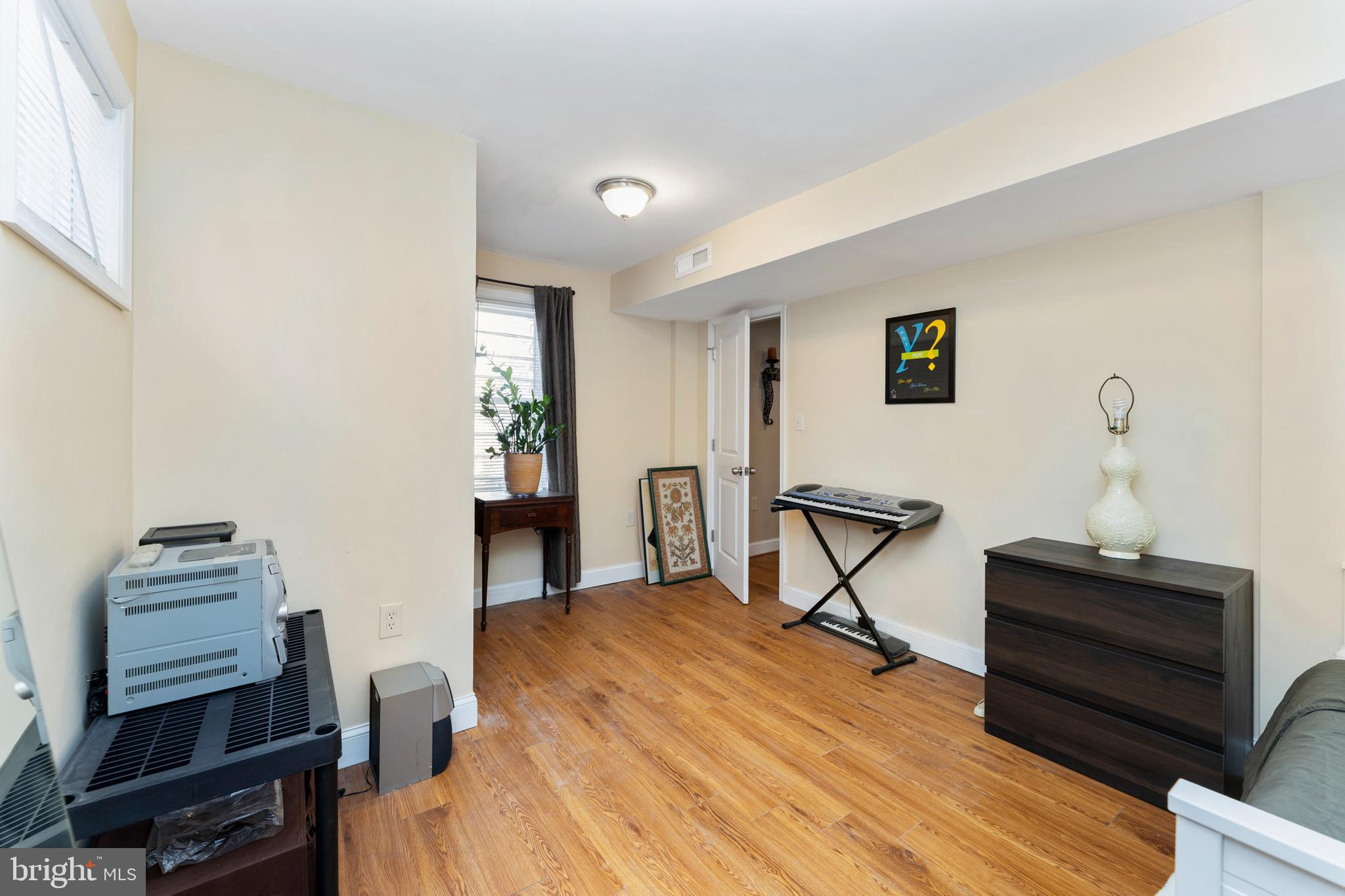 123 Walnut Street Northwest Washington, DC 20012 - Photo 21 of 38 a bedroom with a bed and a chandelier