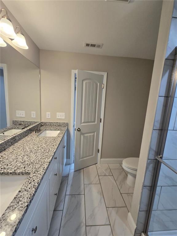 2197 Holders Siding Road Jefferson, GA 30549 - Photo 19 of 29 a bathroom with a granite countertop sink and toilet