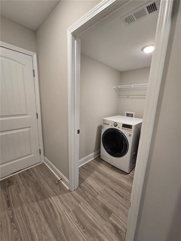 2197 Holders Siding Road Jefferson, GA 30549 - Photo 24 of 29 a room with wooden floor and washing machine
