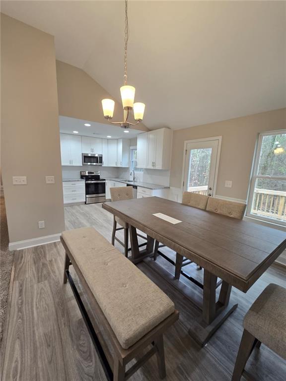 2197 Holders Siding Road Jefferson, GA 30549 - Photo 5 of 29 a view of a dining room with furniture a chandelier and wooden floor
