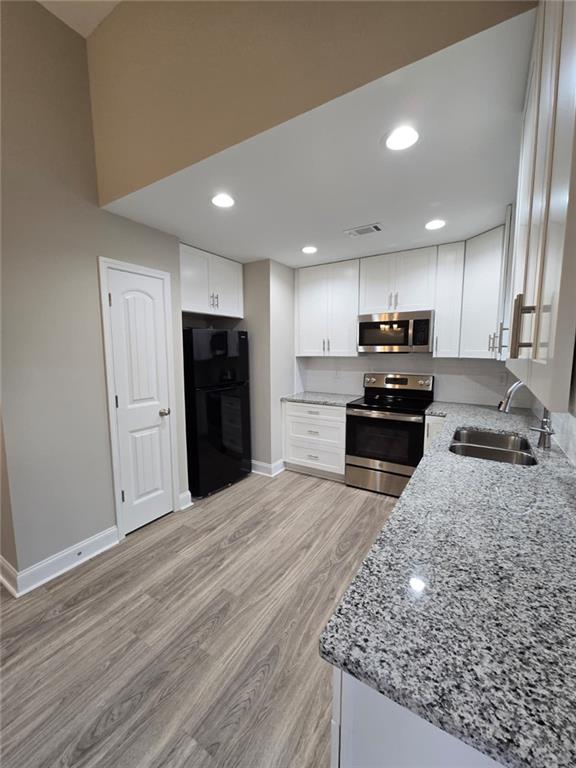 2197 Holders Siding Road Jefferson, GA 30549 - Photo 7 of 29 a kitchen with stainless steel appliances granite countertop a refrigerator stove top oven and sink