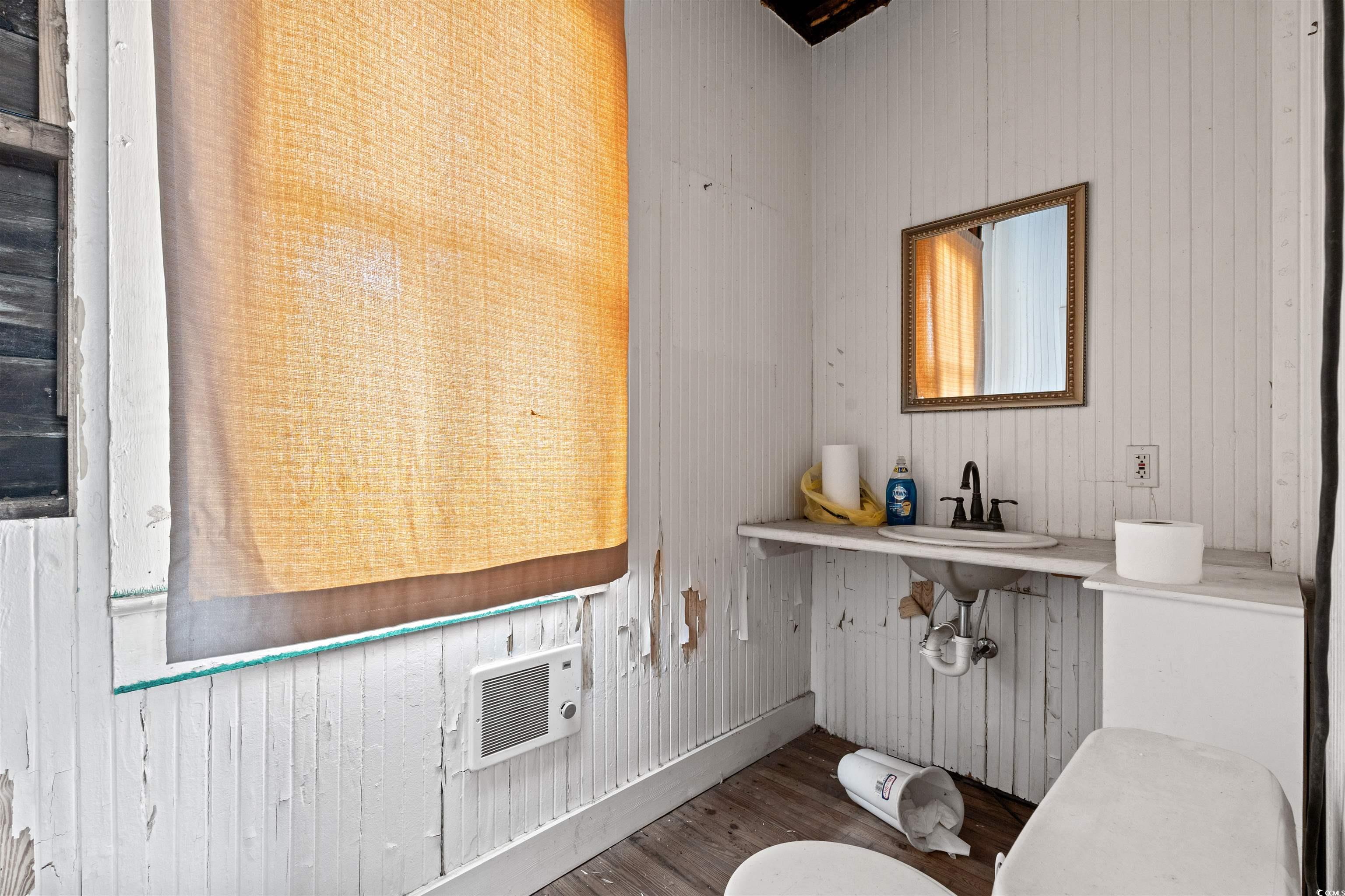 133 Wood Street Georgetown, SC 29440 - Photo 13 of 37 Half bathroom featuring wooden walls and wood finished floors