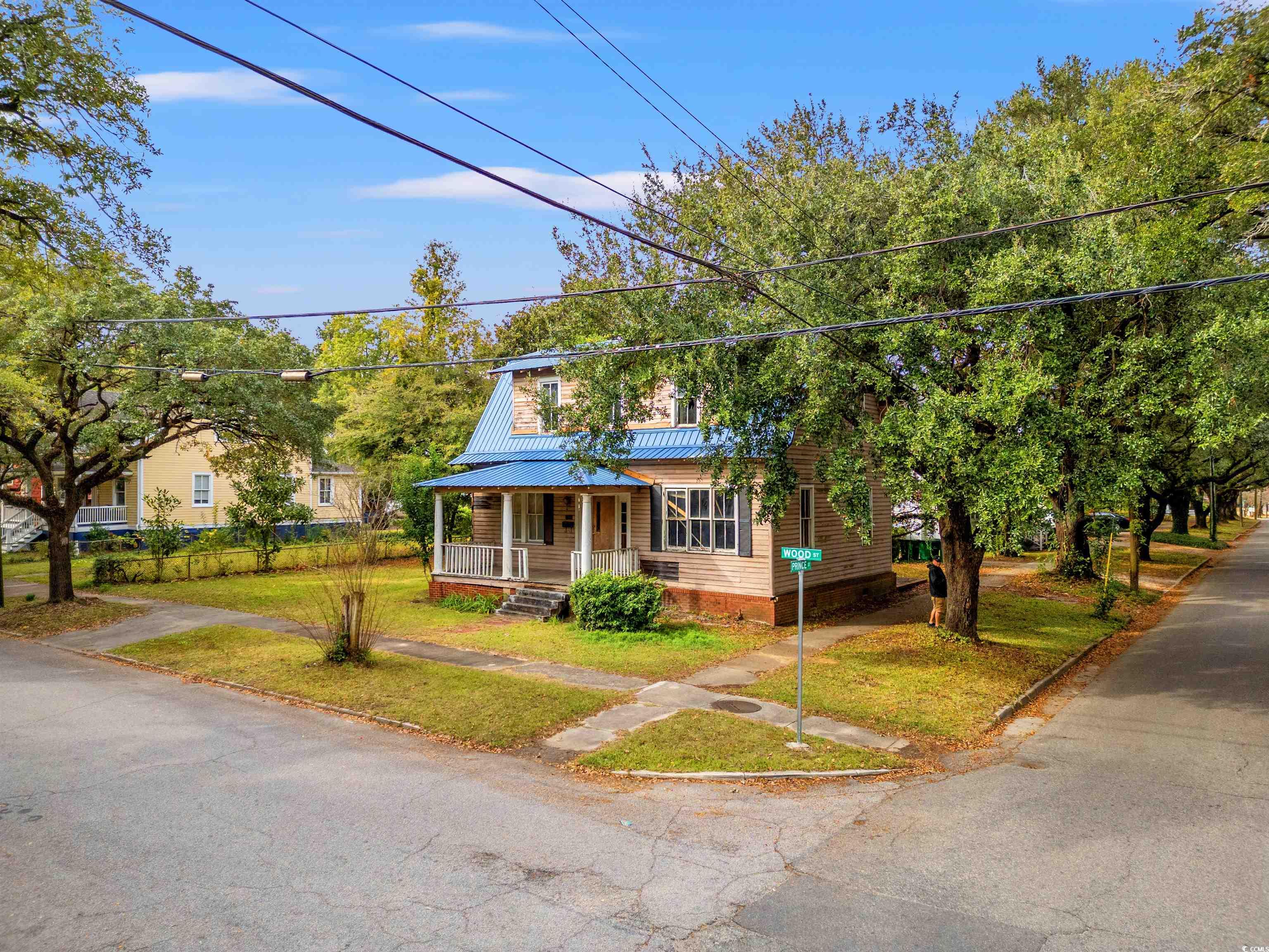 133 Wood Street Georgetown, SC 29440 - Photo 19 of 37 View of front of property featuring covered porch, a front lawn, and a metal roof