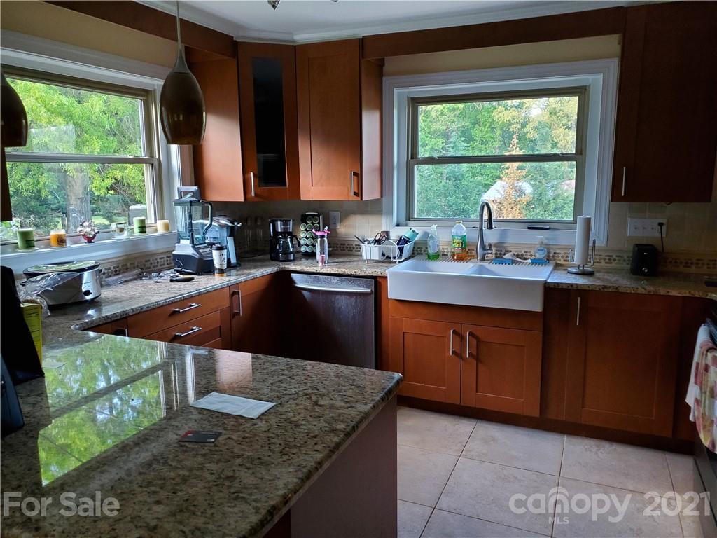 1155 Barnhardt Road China Grove, NC 28023 - Photo 3 of 12 a kitchen with large windows sink and cabinets