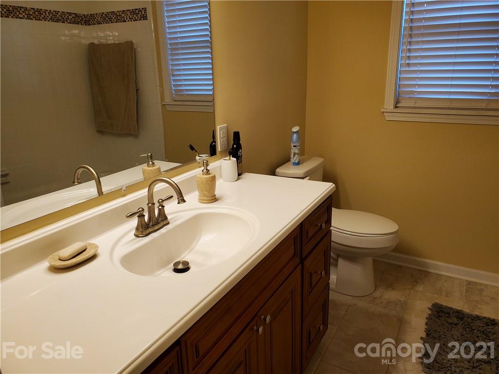 1155 Barnhardt Road China Grove, NC 28023 - Photo 6 of 12 a bathroom with a sink a toilet and mirror