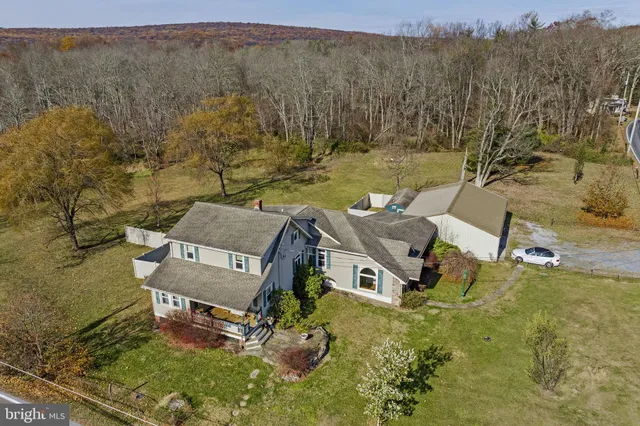 an aerial view of a house with mountain view