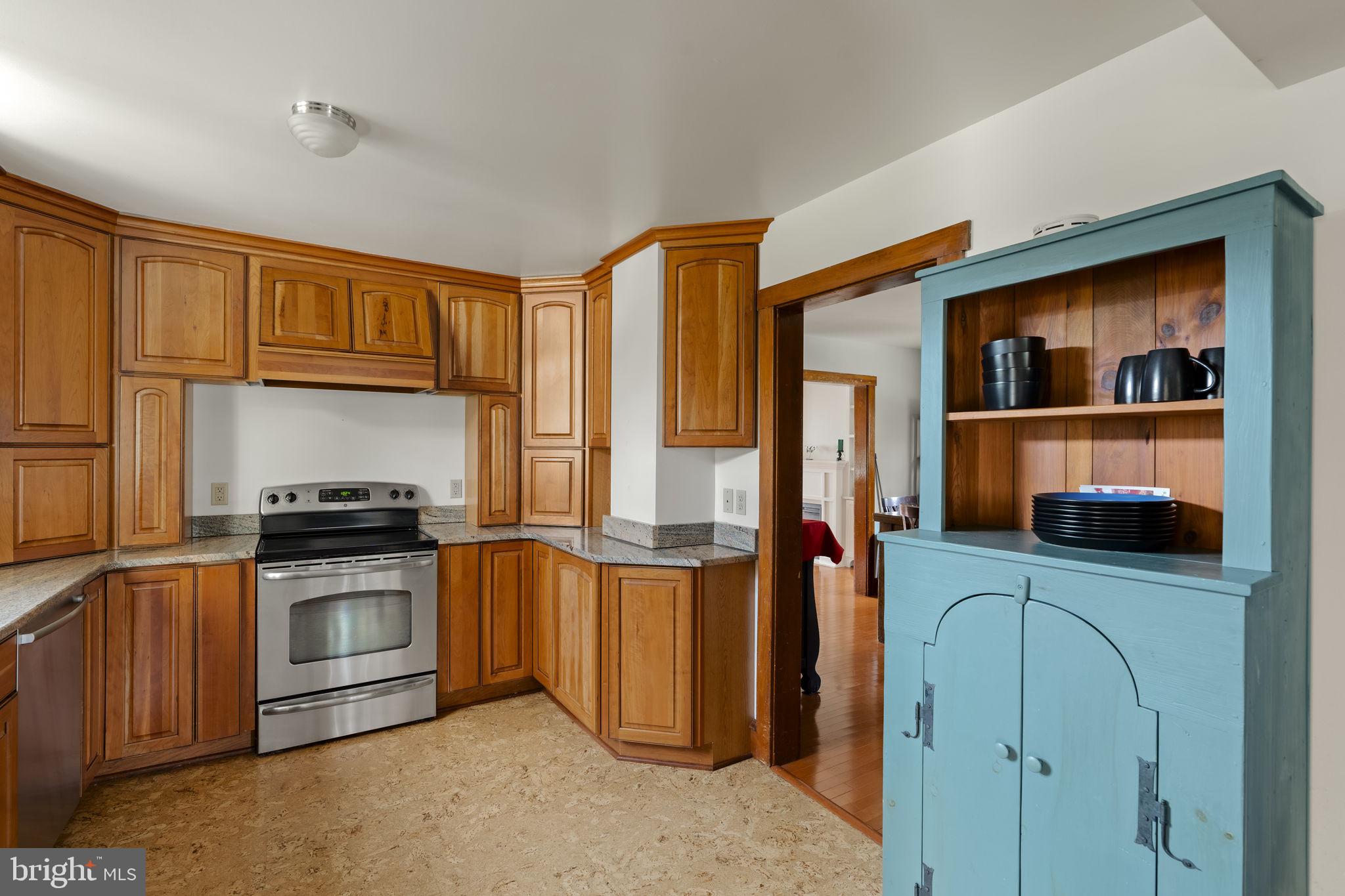 451 Pine Swamp Road Elverson, PA 19520 - Photo 11 of 91 a kitchen with stainless steel appliances granite countertop a stove and a refrigerator